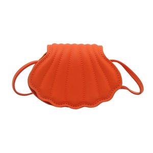 Fashionable bright orange shell-shaped crossbody bag with quilted vertical stripes and strap