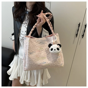Pink quilted tote bag with colorful stitching and a cute plush panda charm detail