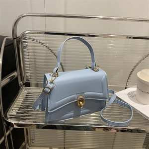 Light blue chic leather handbag with gold twist lock and adjustable shoulder strap