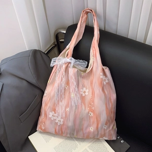 Floral embroidered fabric tote bag with a pink gradient and large lace bow decoration