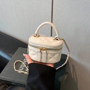 Cream mini quilted chain box bag with gold double zippers and leather strap