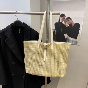 Chic beige woven straw tote bag with white leather straps for summer beach vacation