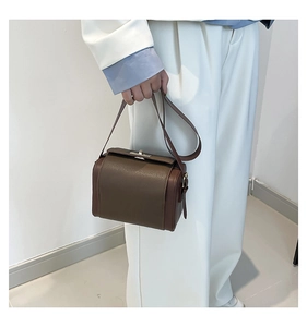 Brown vintage leather shoulder bag detail with lychee texture and metal buckle clasp
