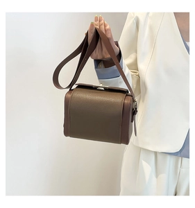 Brown lychee texture leather handbag styled with a white blazer for a chic look