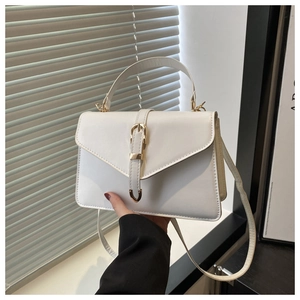 Close-up of white PU leather bag featuring gold buckle detail and adjustable strap