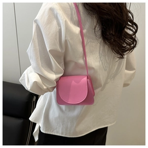 Rear view of a model wearing a pink mini crossbody bag with litchi grain texture