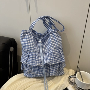 Blue and white gingham tote bag with ruffled layers and a drawstring closure