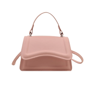 Pink minimalist crossbody bag with elegant scalloped flap and structured top handle design