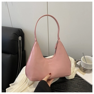 Detailed shot of pink faux leather crescent hobo bag with embossed fashion text