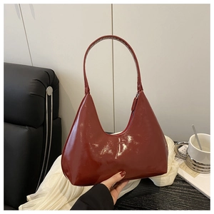 Close-up of burgundy high-gloss hobo bag with sleek zipper and elegant strap detail