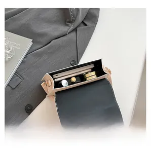 Detail view of the mini crossbody bag interior showing space for phone and makeup