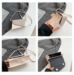 Detail view of cream crossbody bag featuring glitter flap and structured magnetic closure