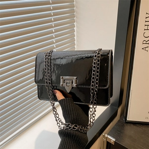 Chic black patent leather crossbody bag with metal chain strap and twist lock closure