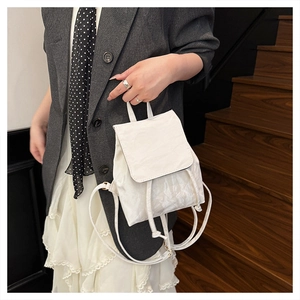 Detail of off-white mini backpack with wrinkled texture fabric and drawstring closure
