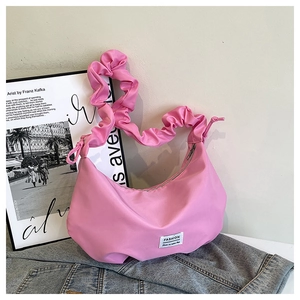 Pink crescent underarm bag featuring a stylish scrunchie handle and fashion label