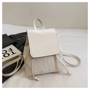 Detail of off-white mini backpack featuring pleated texture and magnetic flap closure