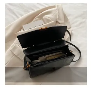 Interior view of black crocodile pattern handbag showing space for phone and wallet