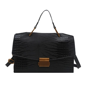 Black crocodile embossed flap handbag with a vertical gold clasp and top handle