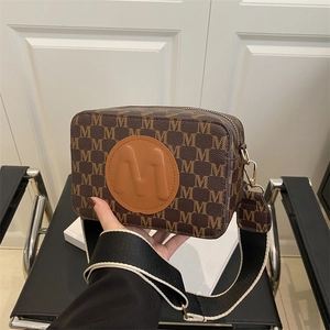 Brown vintage camera bag with letter M prints and striped wide shoulder strap