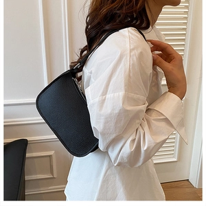 Detailed macro view of the black lychee texture fabric on this stylish underarm shoulder bag