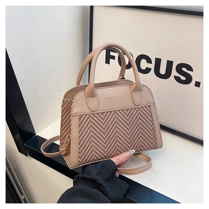 Detail of contrast color beige and brown PU leather and fabric weave shoulder bag