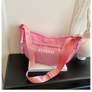 Pink nylon half-moon crossbody bag with white FASHION lettering and adjustable strap