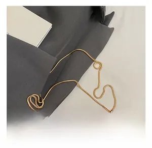 Detail of round box evening bag with golden snake chain and metallic hardware