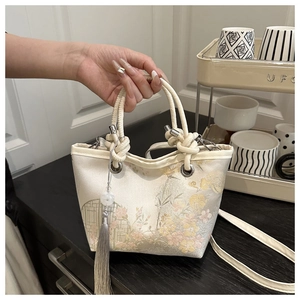 Close-up of traditional Chinese embroidery bucket bag with elegant floral patterns and silk tassel