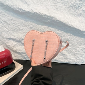 Pink heart-shaped crossbody bag with crocodile texture and silver chain details