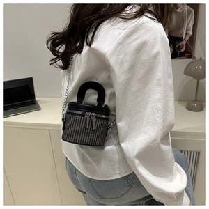 Chic woven texture bucket bag with leather handle and silver chain strap on model