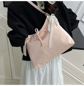 Detail of pink tote bag with drawstring bow and pearl lace ribbon charm