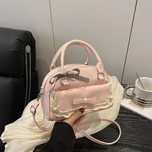 Pink faux leather handbag with lace trim, 3D bow detail and adjustable shoulder strap