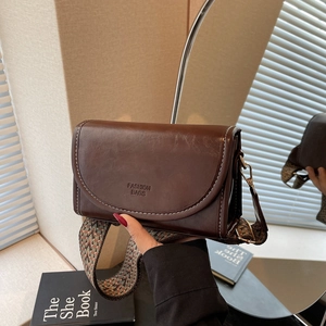 Retro dark brown leather square shoulder bag with geometric woven strap and flap closure