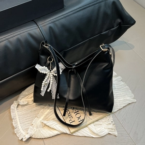 Large black minimalist hobo shoulder bag with a lace pearl bow pendant detail