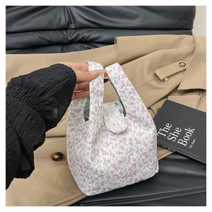 Detailed shot of floral canvas tote bag featuring delicate lace trim and pink flower patterns