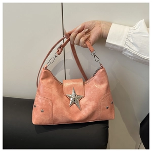 Close-up of pink Y2K shoulder bag featuring metallic silver star rivets and PU leather texture
