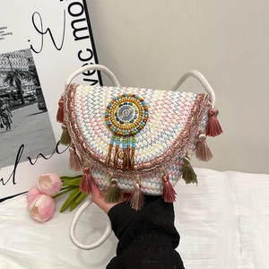Handmade bohemian straw crossbody bag with colorful embroidery and tassel trim