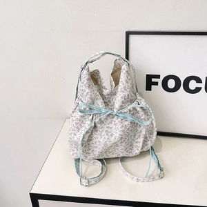 Floral canvas tote bag with drawstring closure and blue checkered bow decoration