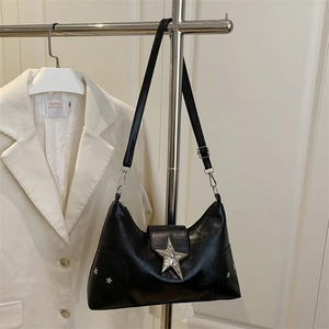 Black hobo shoulder bag with large silver star buckle and rivets on soft leather texture