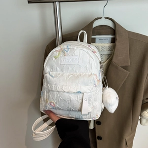 White quilted floral embroidery backpack with plush charm for school and travel