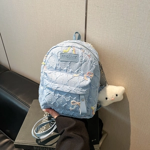 Light blue quilted mini backpack with sequined bow and fluffy cloud charm accessory