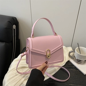 Stylish pink square handbag with elegant gold-tone lock and adjustable shoulder strap