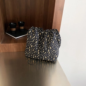 Floral nylon drawstring bucket bag with yellow flower patterns and adjustable strap