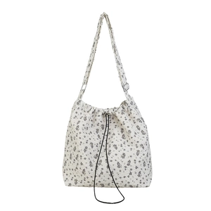 Floral nylon cradle shoulder bag with drawstring closure and adjustable strap