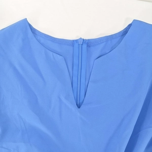 Detail of royal blue V-neckline with functional zipper closure and high-quality woven fabric