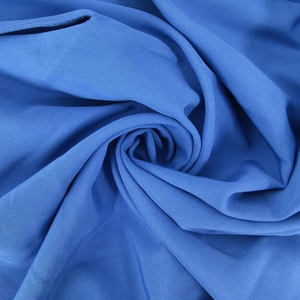 Macro view of royal blue knitted fabric with elastic texture and smooth drape