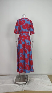 Back view of an elegant blue and red floral print maxi dress displayed on a mannequin.