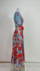 Side view of an elegant blue and red floral print long dress displayed on a mannequin