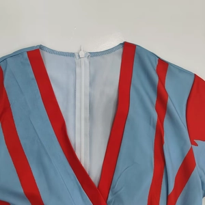 Close-up detail of the V-neck and invisible zipper on a blue striped dress