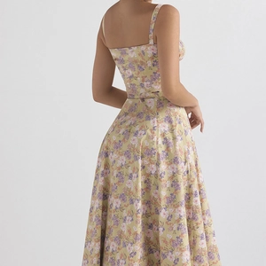 Back view of a yellow floral slip dress with delicate straps and a flared skirt